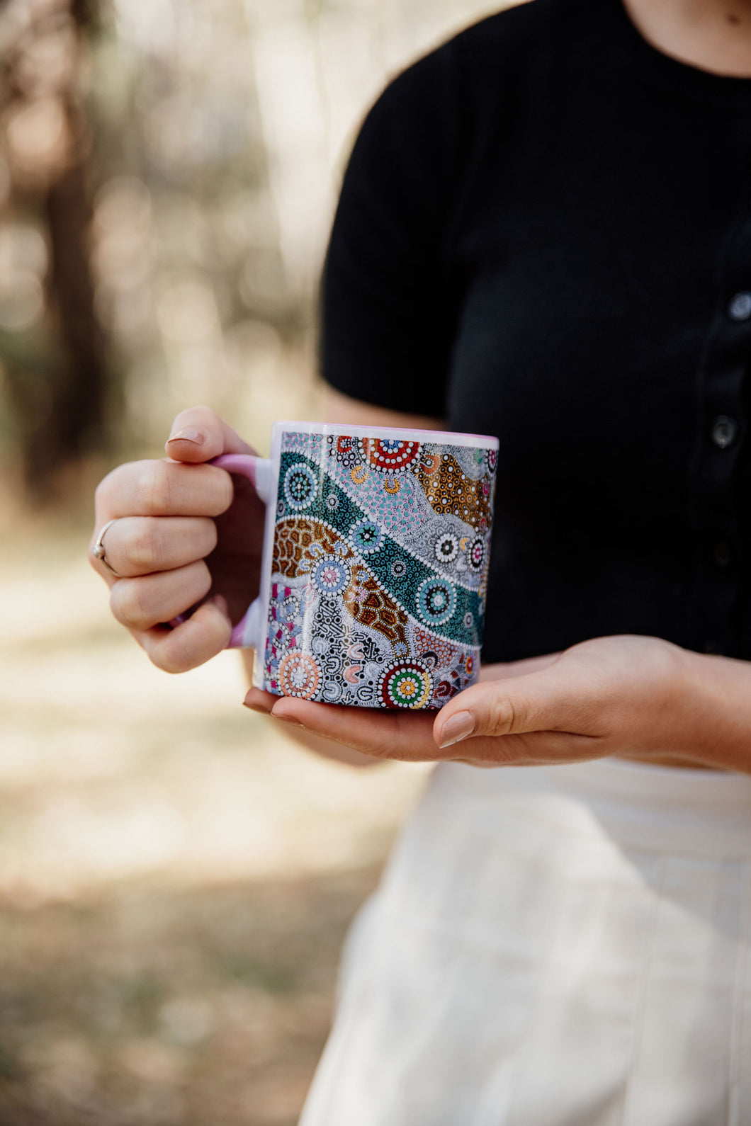 These Wiradjuri Art standard sized coffee mugs come printed with the Wiradjuri River People artwork. The mug can be purchased in the colour options of blue, pink, yellow or black for the handle and inside. Indigenous Art Aboriginal Art First Nations Art