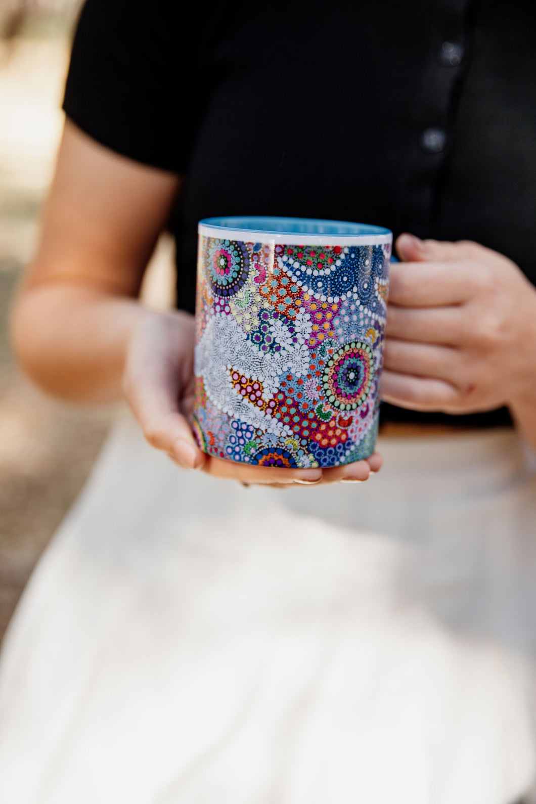 These Wiradjuri Art standard sized coffee mugs come printed with the Kangaroo Dreaming 2 artwork. The mug can be purchased in the colour options of blue, pink, yellow or black for the handle and inside. Indigenous Art Aboriginal Art First Nations Art
